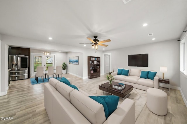 living room featuring ceiling fan and light wood-type flooring