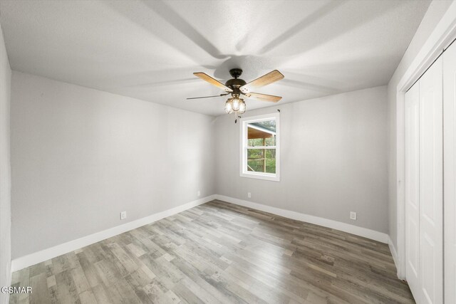 unfurnished bedroom with a closet, ceiling fan, and light hardwood / wood-style floors