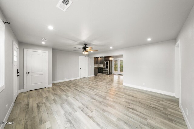 unfurnished living room with ceiling fan and light hardwood / wood-style flooring