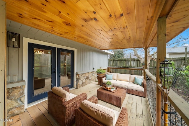 wooden deck featuring an outdoor living space and french doors