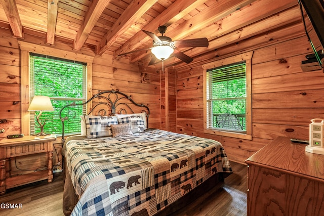 bedroom featuring beamed ceiling, wood finished floors, wood walls, and wood ceiling