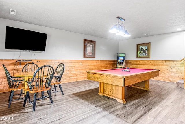playroom featuring wainscoting, billiards table, wood finished floors, a textured ceiling, and wood walls