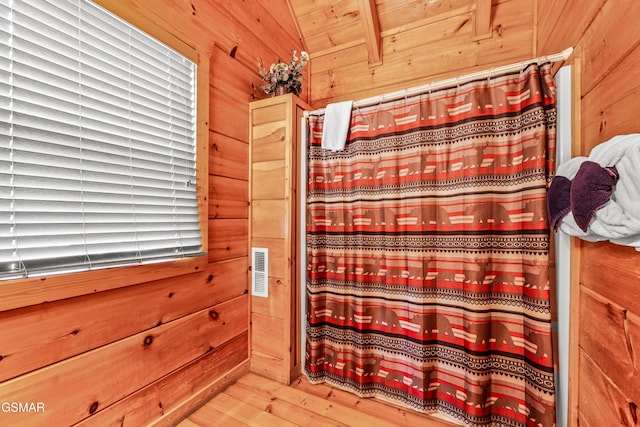 detailed view of wooden walls and a shower with curtain