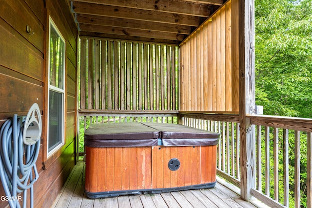 wooden deck featuring a hot tub