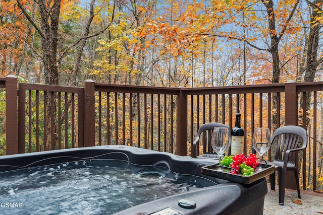 wooden deck featuring a hot tub