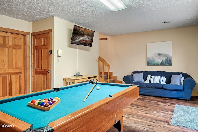 playroom featuring wood finished floors, a textured ceiling, and billiards