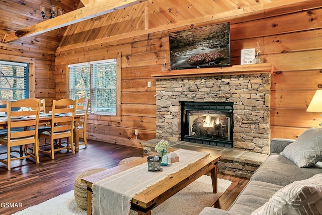 living room with wood-type flooring, wood walls, a stone fireplace, and wood ceiling