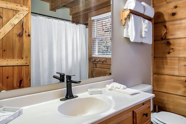 full bath with toilet, vanity, and a shower with curtain