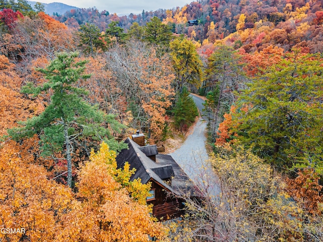 view from above of property featuring a heavily wooded area