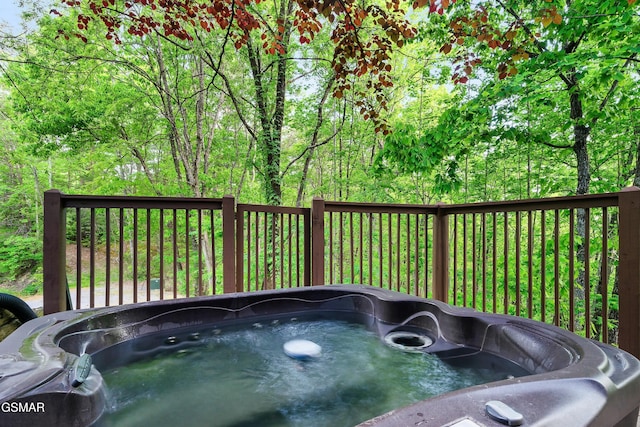 wooden deck with a hot tub