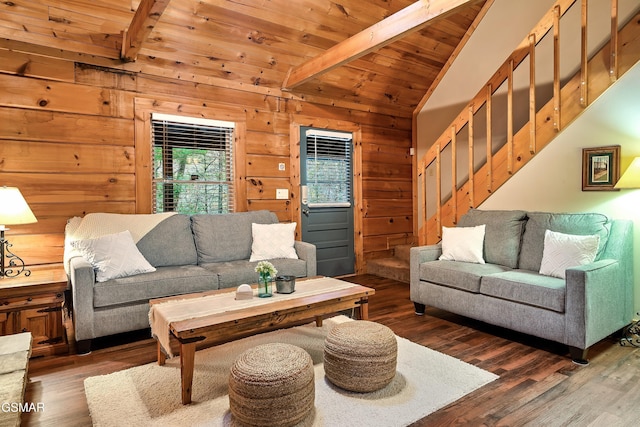 living area with wood finished floors, wood walls, wooden ceiling, and stairs