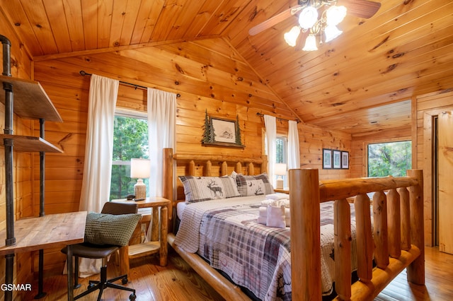 bedroom with wooden walls, wood-type flooring, and vaulted ceiling