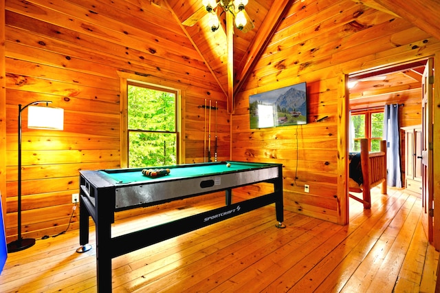 playroom with wood walls, light hardwood / wood-style floors, vaulted ceiling, and billiards