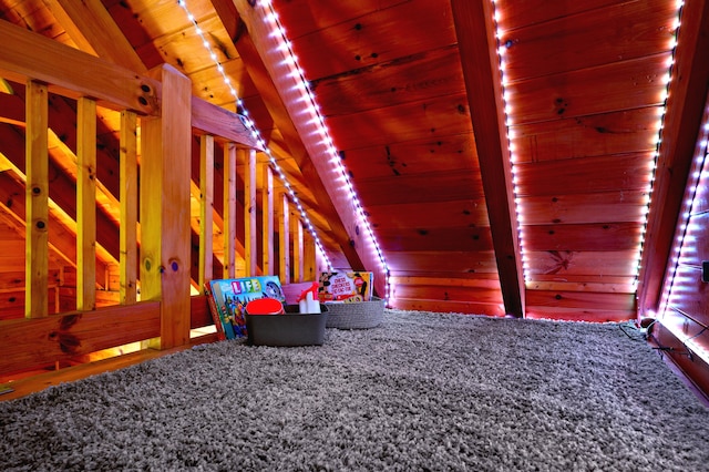 interior space with carpet flooring, lofted ceiling with beams, and wooden ceiling