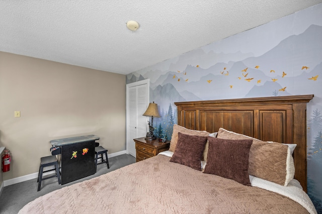 bedroom with dark carpet and a textured ceiling