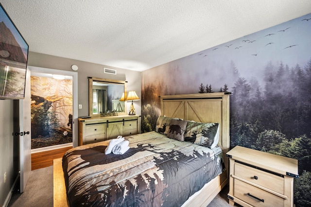 carpeted bedroom featuring a textured ceiling