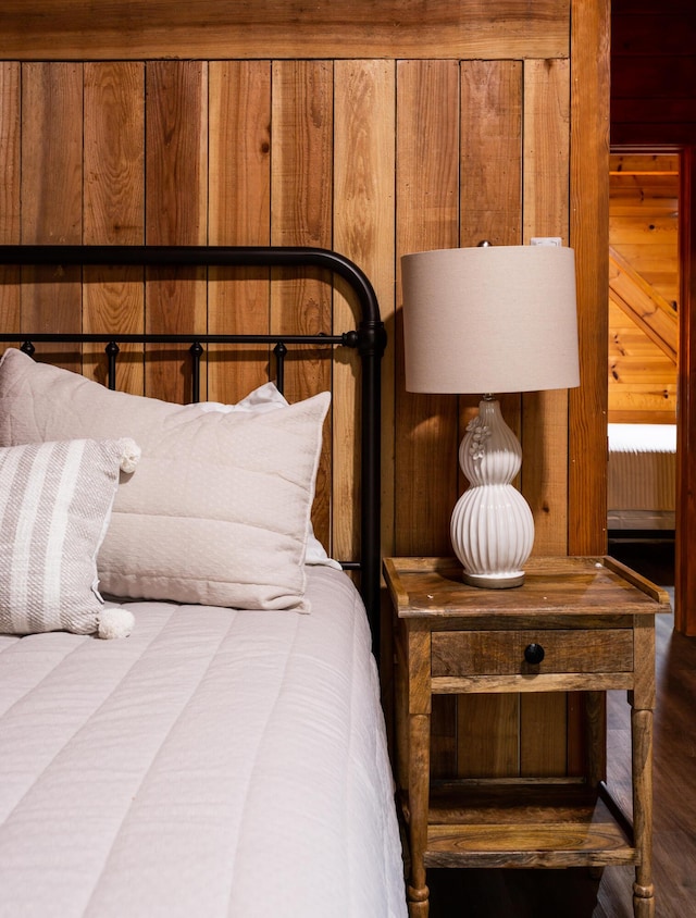 bedroom featuring wood walls