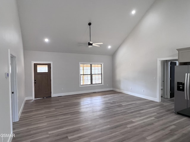 foyer entrance featuring a ceiling fan, wood finished floors, baseboards, high vaulted ceiling, and recessed lighting