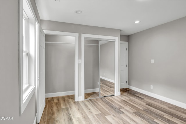2438 Daniels Dr, Morristown, TN 37813 - unfurnished bedroom featuring light wood-style flooring, baseboards, recessed lighting, and two closets