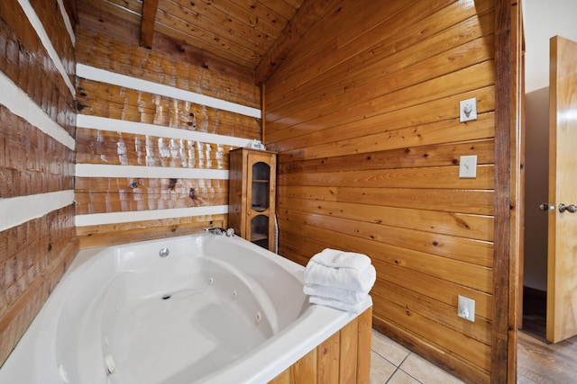 full bath featuring tile patterned floors, vaulted ceiling, wooden ceiling, a jetted tub, and wooden walls