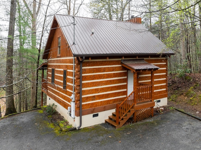 view of outbuilding featuring aphalt driveway and an attached garage