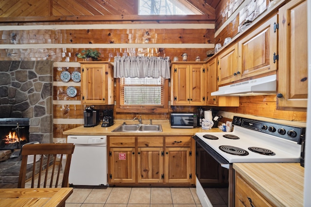 kitchen with light countertops, dishwasher, under cabinet range hood, range with electric cooktop, and a sink