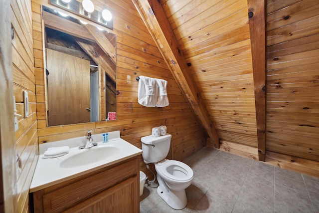 bathroom with tile patterned flooring, vanity, toilet, wooden walls, and beamed ceiling