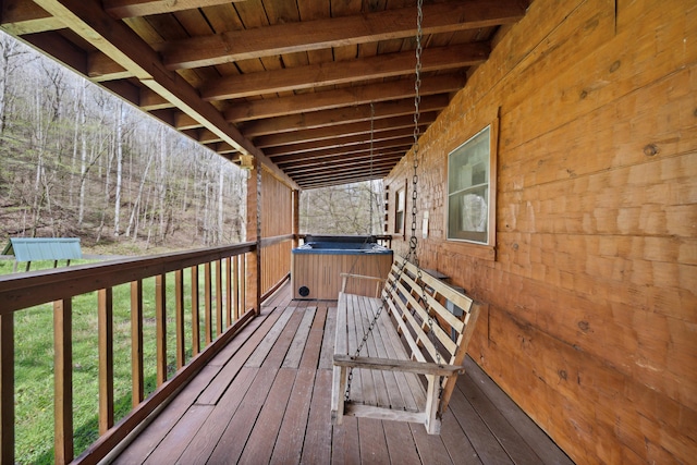 wooden deck featuring a hot tub