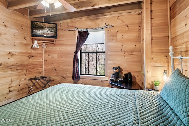 unfurnished bedroom featuring ceiling fan and wood walls