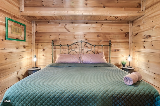 bedroom featuring wooden ceiling and wooden walls