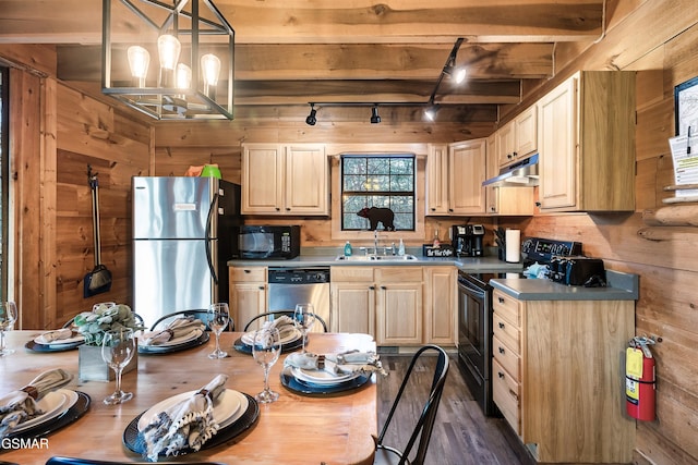 kitchen with wooden walls, sink, black appliances, light brown cabinets, and beam ceiling