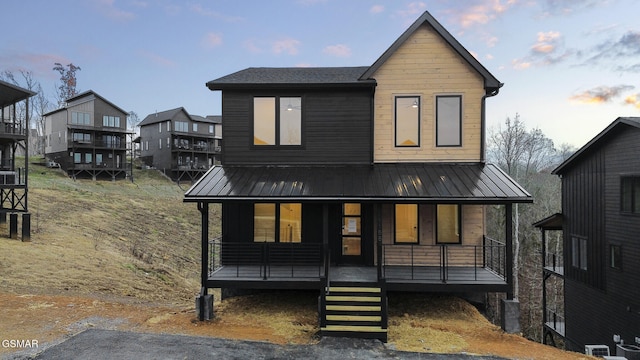 view of front of house with central AC unit and a porch