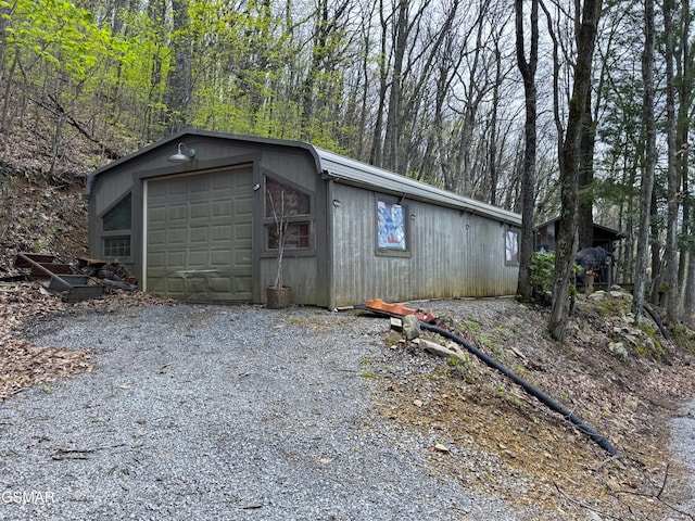 exterior space featuring an outdoor structure and gravel driveway