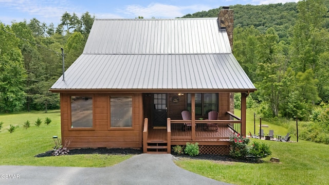 3955 Millers Ridge Way, Sevierville, TN 37862 - view of front facade with a chimney, a front yard, a metal roof, and a view of trees
