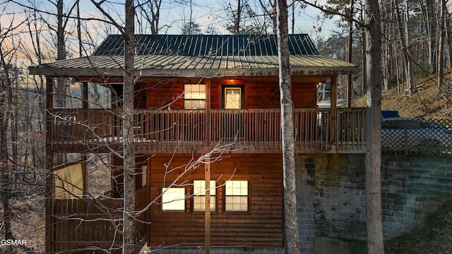 view of property exterior featuring metal roof and faux log siding