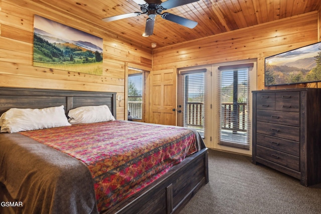 bedroom featuring multiple windows, wood ceiling, wood walls, and access to outside