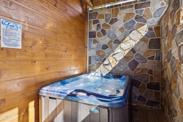 details featuring stone siding and a hot tub