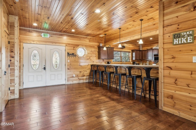 interior space featuring recessed lighting, dark wood-style floors, wooden ceiling, and wood walls