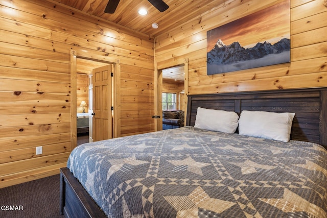 bedroom with wooden ceiling, carpet flooring, and wood walls