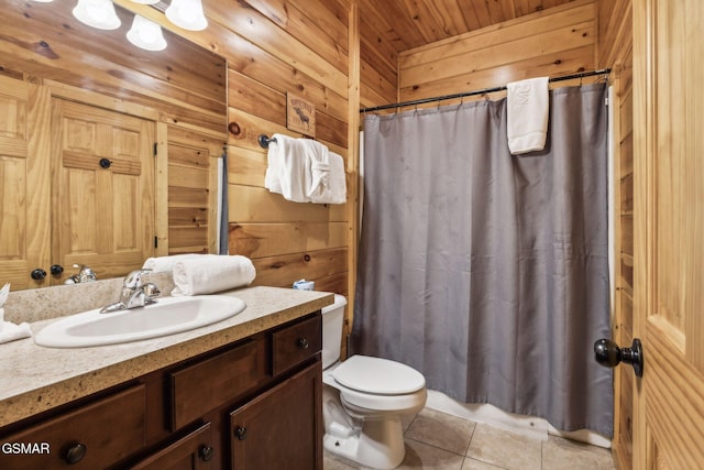 bathroom with wooden walls, curtained shower, toilet, tile patterned floors, and vanity