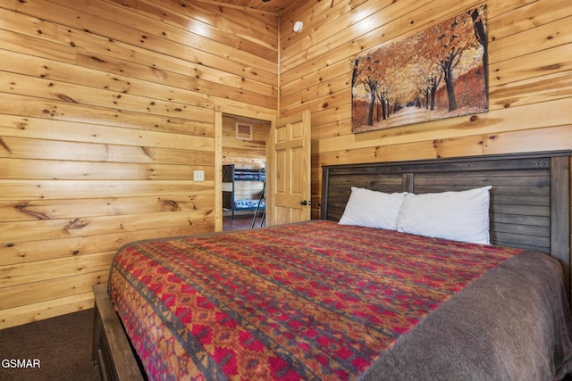 bedroom featuring wooden walls and carpet