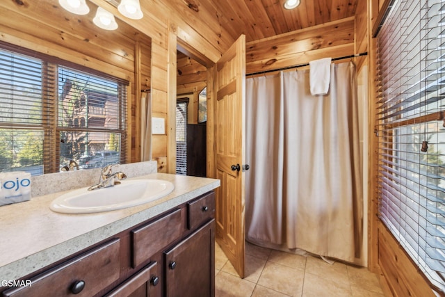 bathroom featuring tile patterned flooring, wooden ceiling, vanity, and wood walls