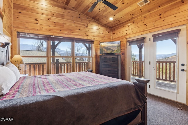 carpeted bedroom featuring visible vents, wooden walls, wooden ceiling, access to exterior, and vaulted ceiling