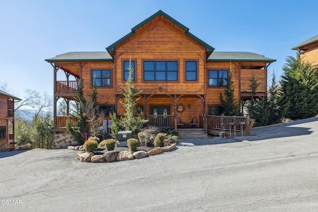 view of front of home featuring covered porch and a balcony