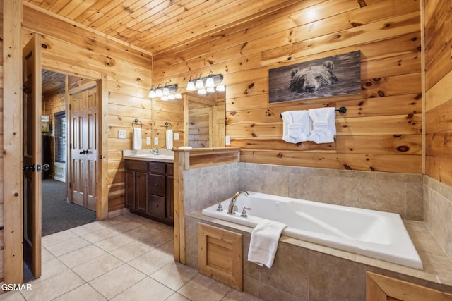 bathroom with wooden walls, tile patterned floors, wood ceiling, a bath, and vanity