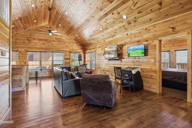 living room featuring wood walls, wood ceiling, hardwood / wood-style flooring, high vaulted ceiling, and a ceiling fan