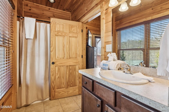 bathroom featuring wooden walls, wood ceiling, vanity, and tile patterned flooring