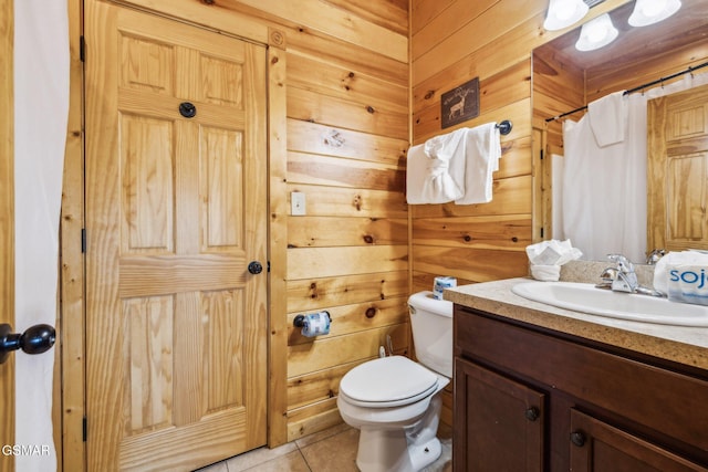 full bathroom with tile patterned floors, vanity, toilet, and wooden walls