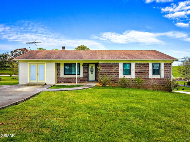 ranch-style house with french doors and a front lawn