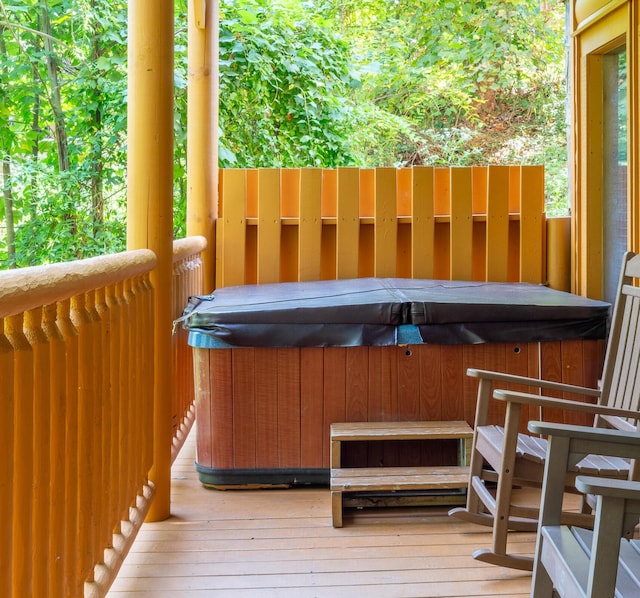 wooden terrace featuring a hot tub